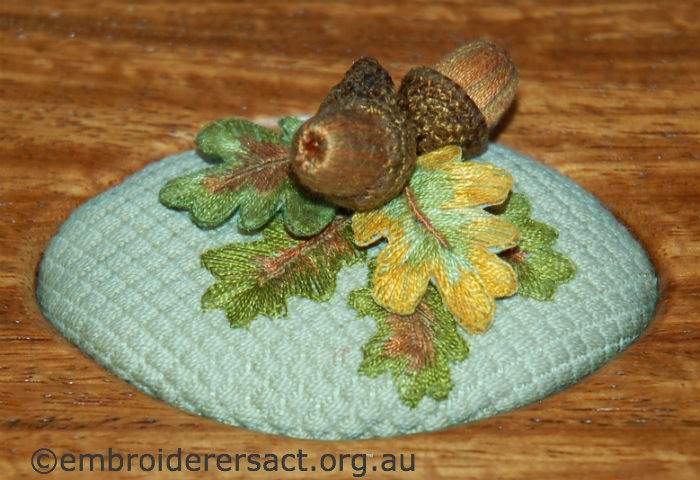 Detail of stumpwork acorns stitched by Yvonne Kingsley