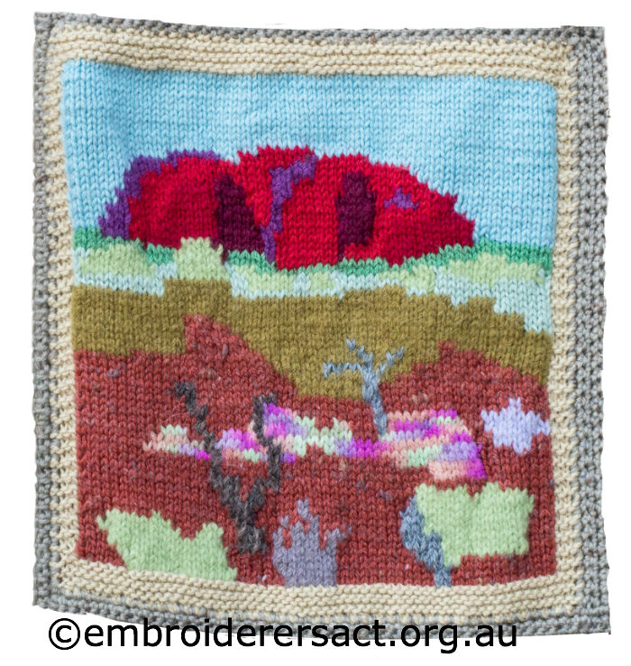 Knitted rug with embroidery